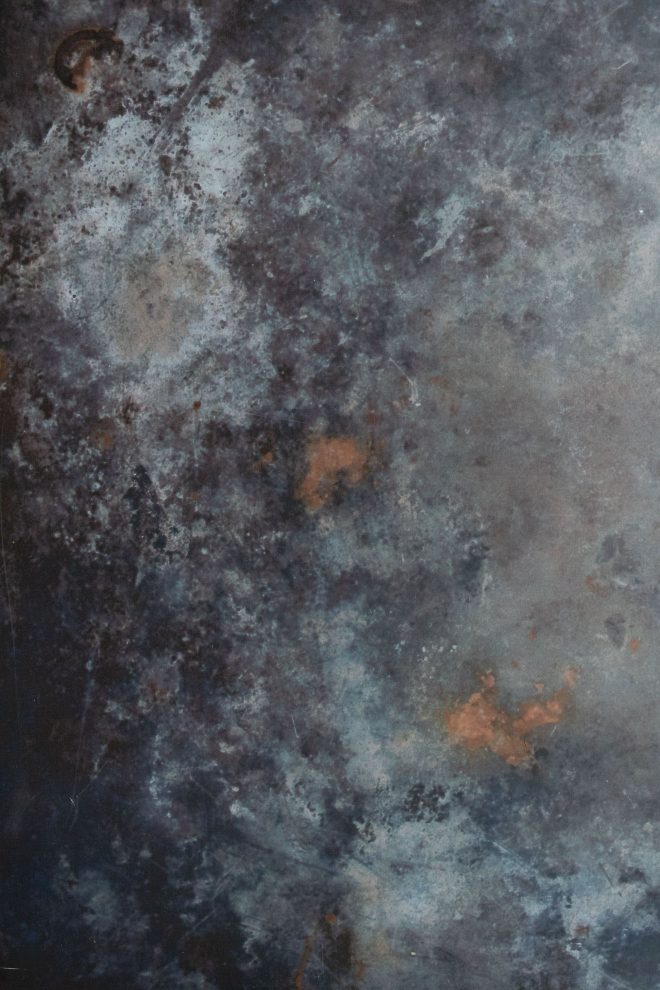 Close up shot of a marbled backdrop of dark gray, light gray, and copper tones.photograph by Lauren Caris Short of Food Photography Academy