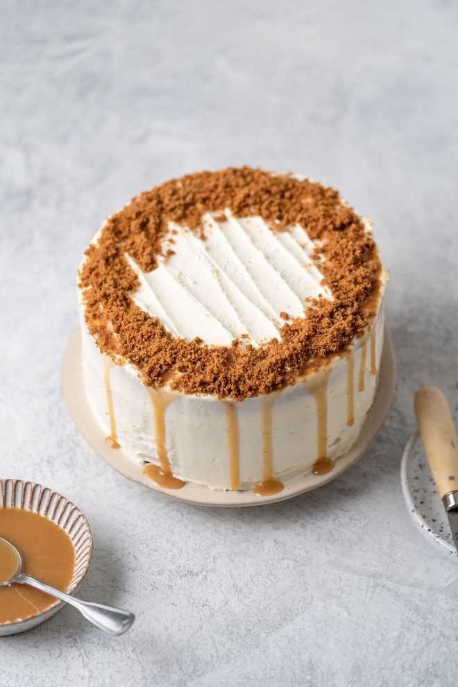 Final cake with frosting, caramel drizzle and crumbs