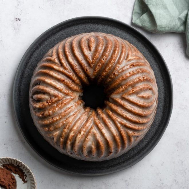 a brown bundt cake sits on a plate