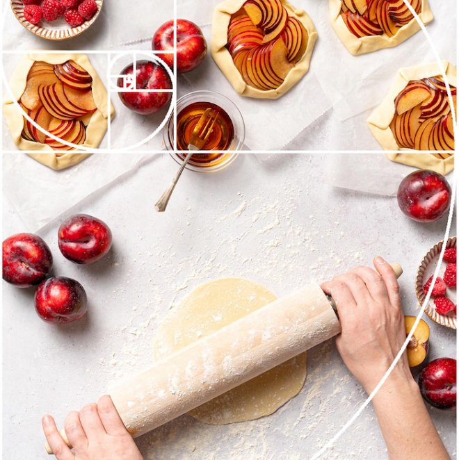 Image of Lauren Short using a rolling pin to roll dough surrounded by various apples and apple tarts overlaid with text that reads How to Use Composition Techniques to Improve Your Food Photography.