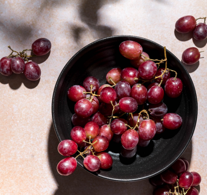 A bowl of grapes photographed with gobo lighting